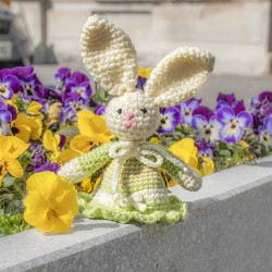 Crocheted Easter bunny in light green dress, handmade bunny decoration with spring flowers